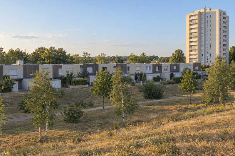 Tour de quinze étages dominant une rangée de maisons de ville basses